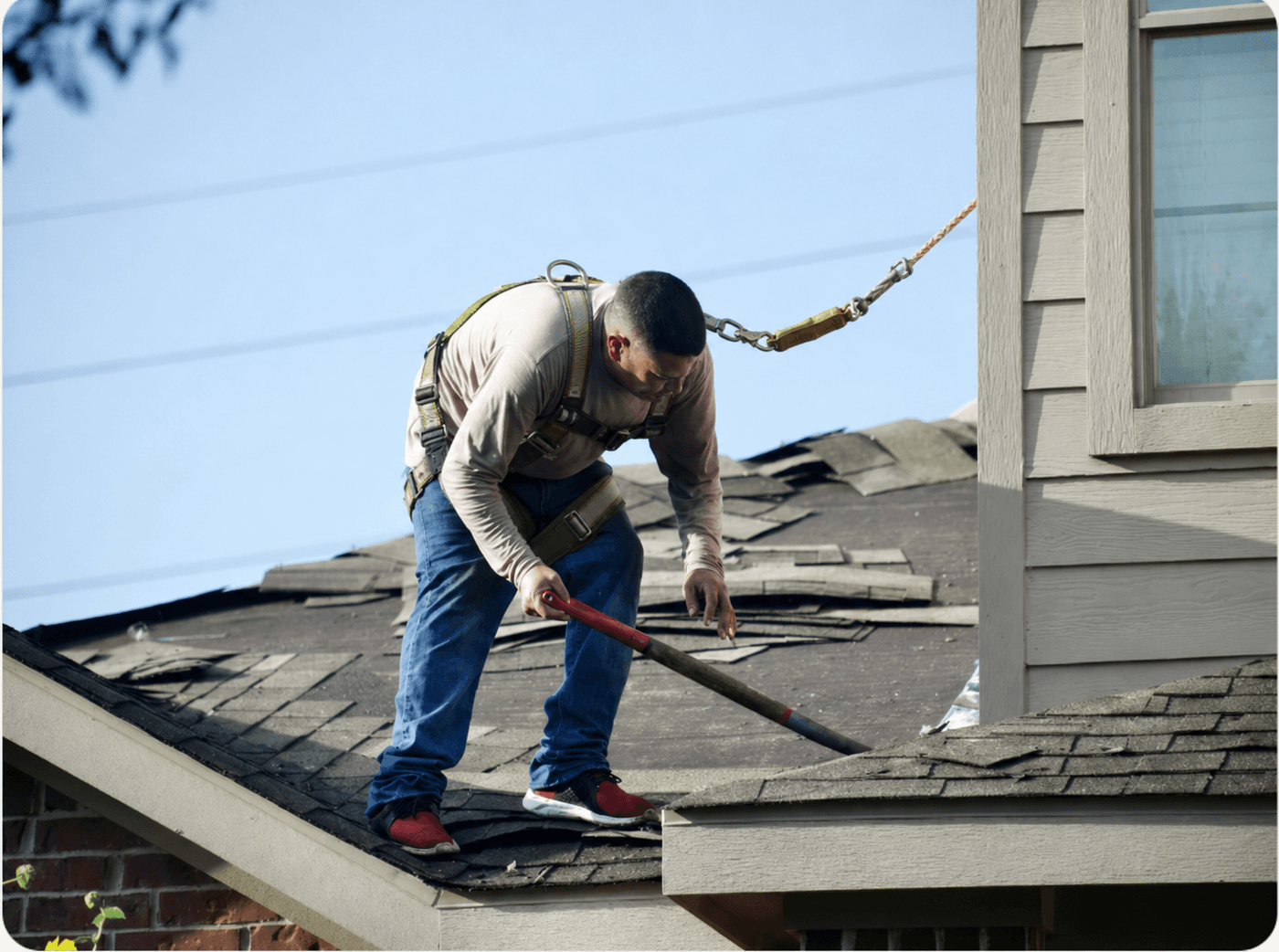 A Robinhood crew tearing off a storm-damaged roof